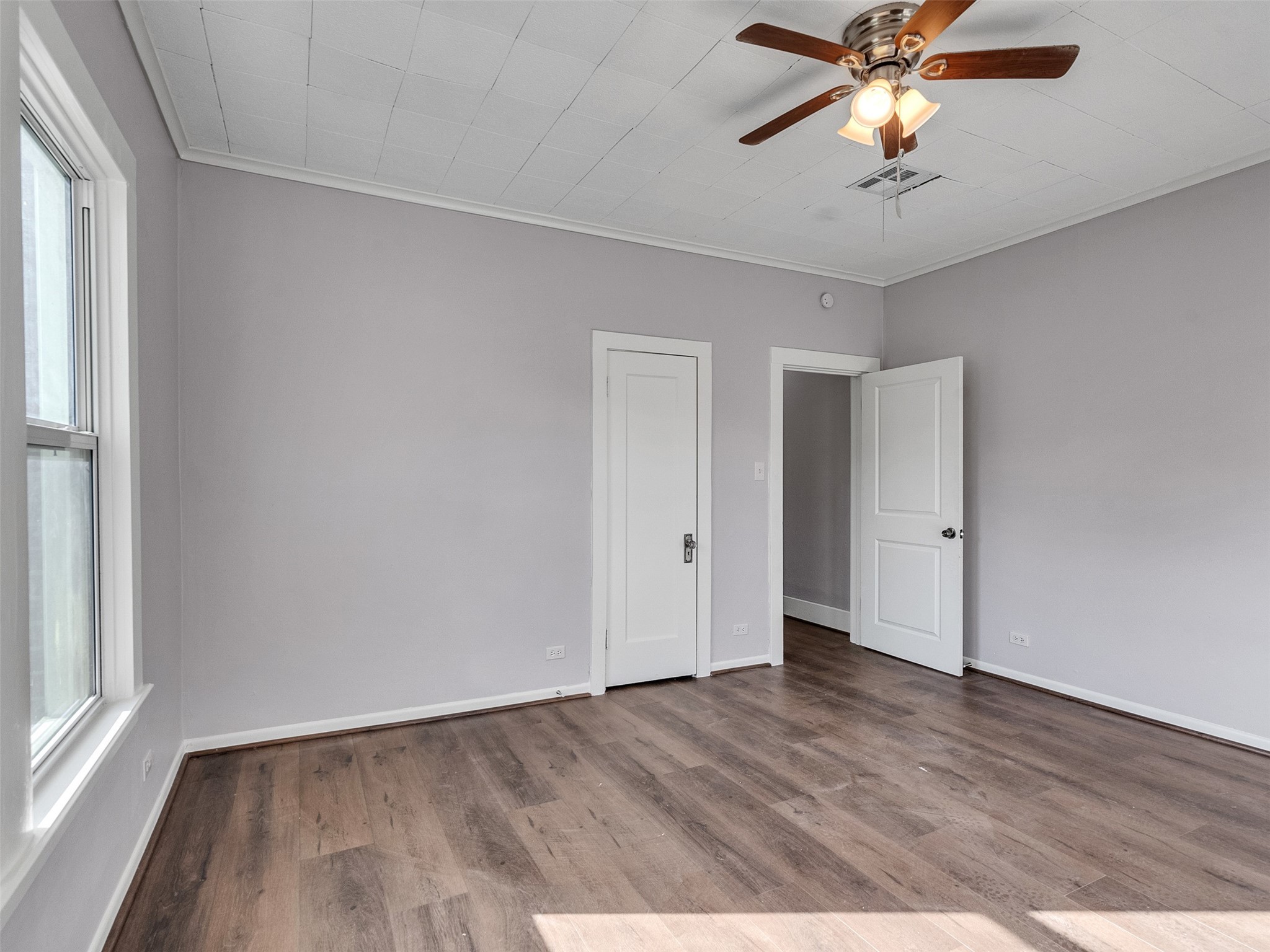 4625 Bell Street Houston, TX 77023 - Photo 15 of 33 an empty room with wooden floor fan and windows