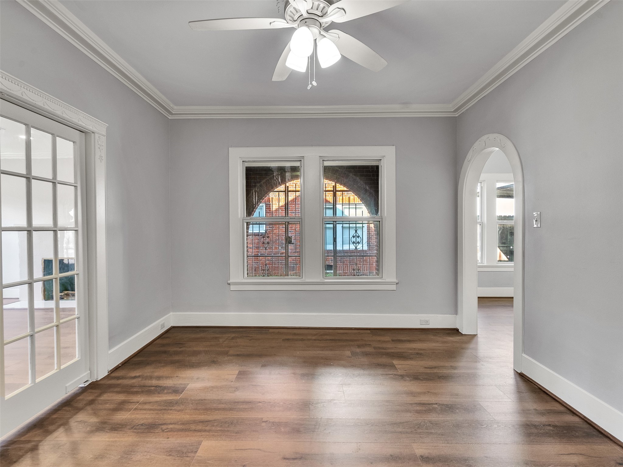4625 Bell Street Houston, TX 77023 - Photo 18 of 33 an empty room with wooden floor chandelier and windows