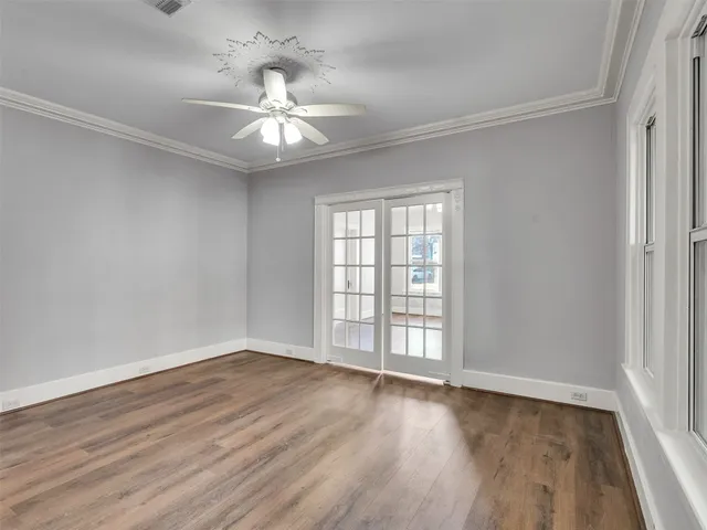wooden floor in an empty room with a window