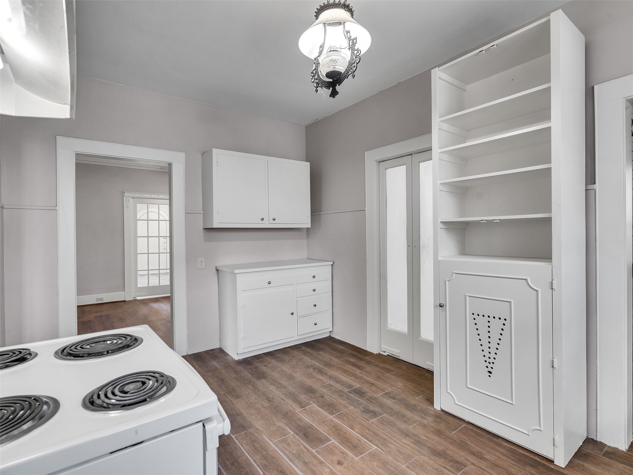 4625 Bell Street Houston, TX 77023 - Photo 25 of 33 a kitchen with a stove cabinets and wooden floor