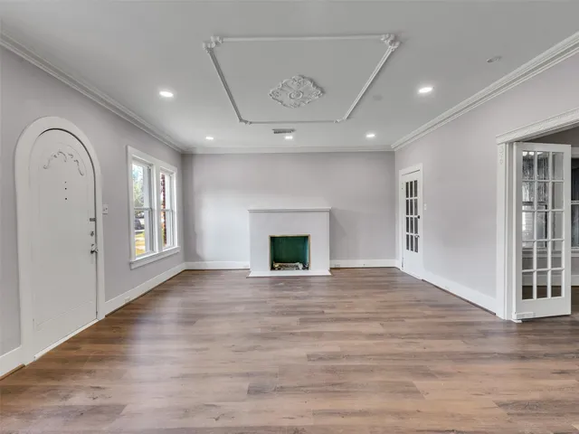 a view of an empty room with a fireplace and a window