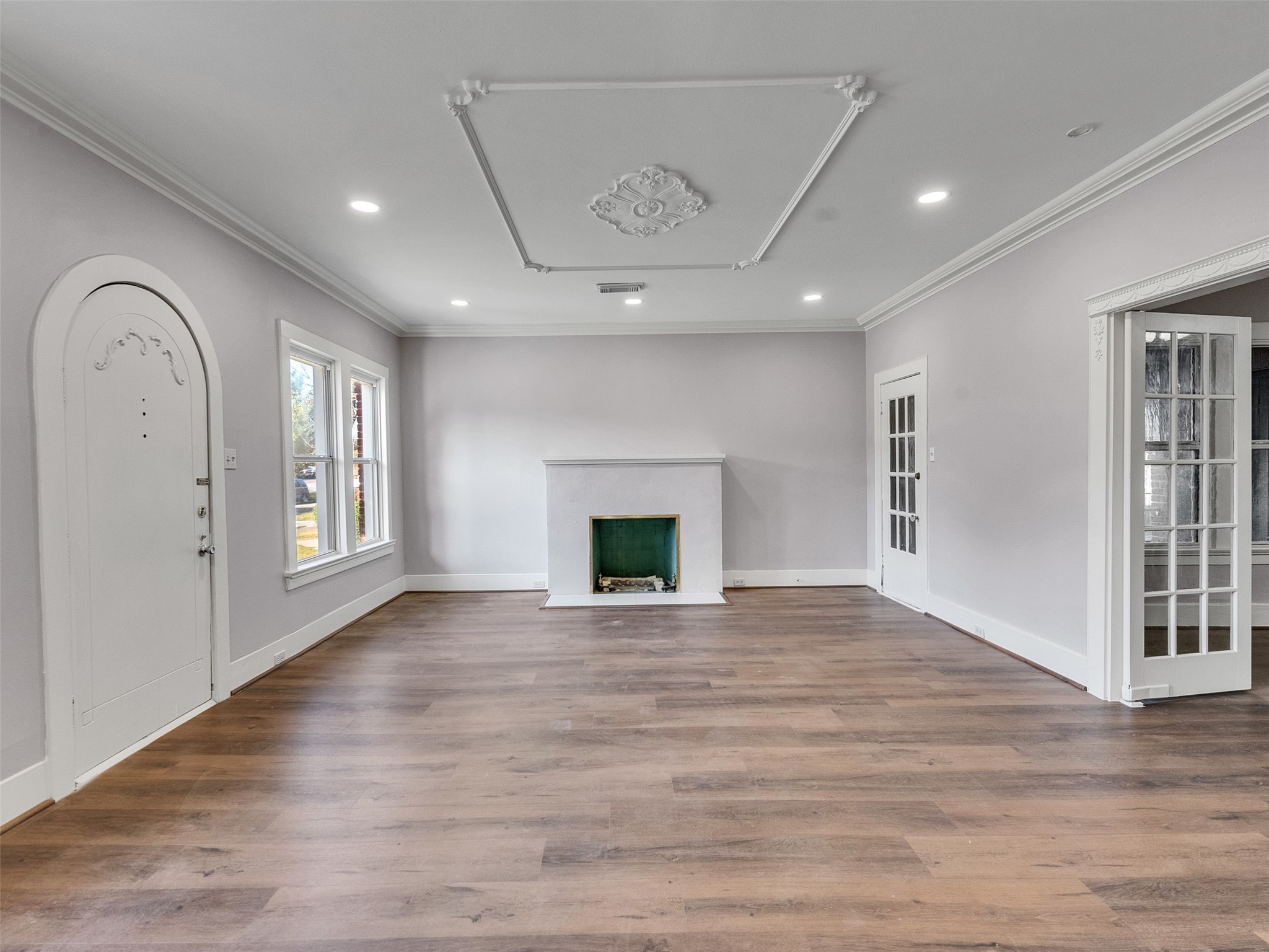 4625 Bell Street Houston, TX 77023 - Photo 3 of 33 a view of an empty room with a fireplace and a window