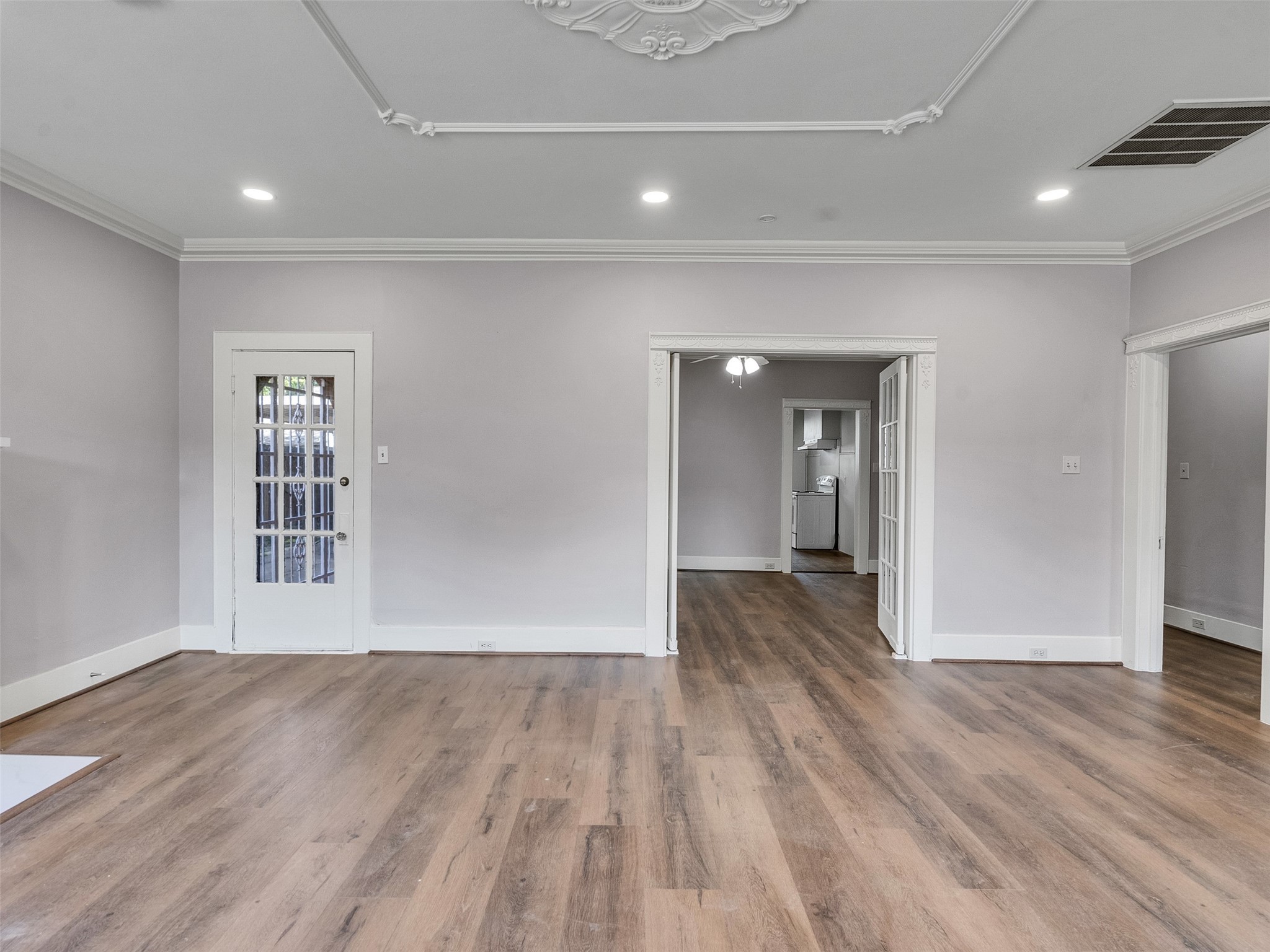 4625 Bell Street Houston, TX 77023 - Photo 4 of 33 a view of a big room with wooden floor and windows