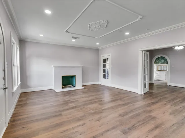 a view of an empty room with window and fire place