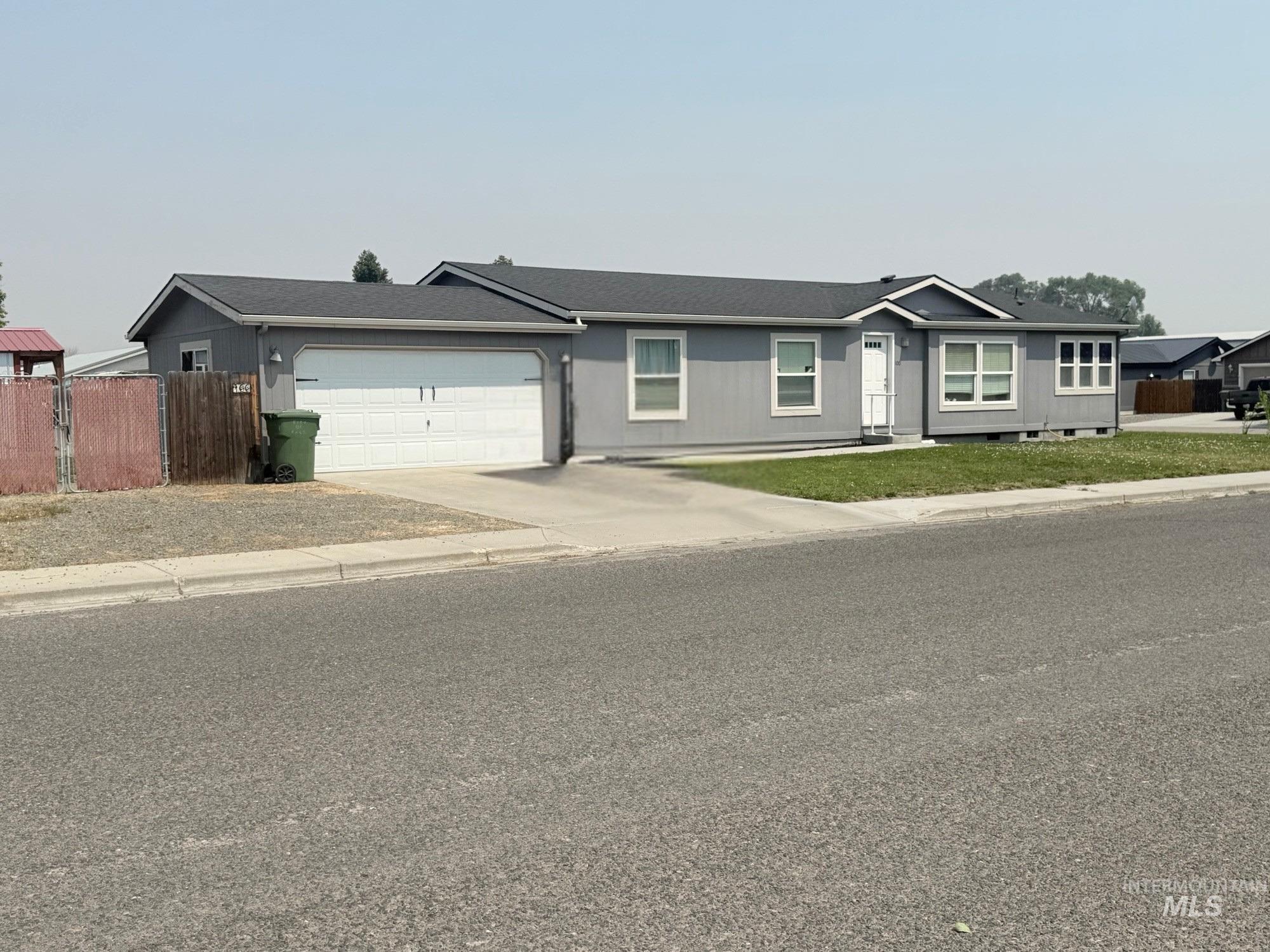 100 Ellsworth Street Vale, OR 97918 - Photo 2 of 25 Single-story residence featuring light gray siding and a dark gray shingled roof