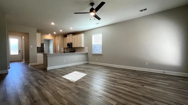 a view of a kitchen with a sink and microwave area