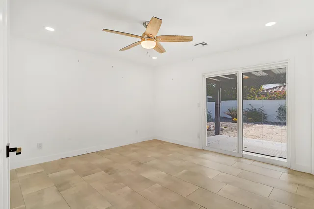 a large kitchen with a large counter top a sink stainless steel appliances and cabinets