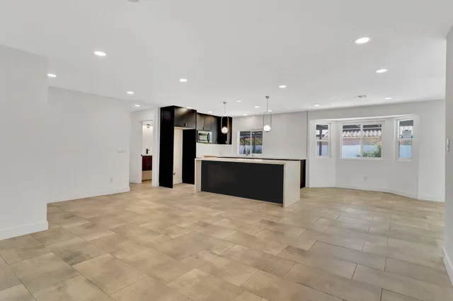 a view of an empty room with a fireplace