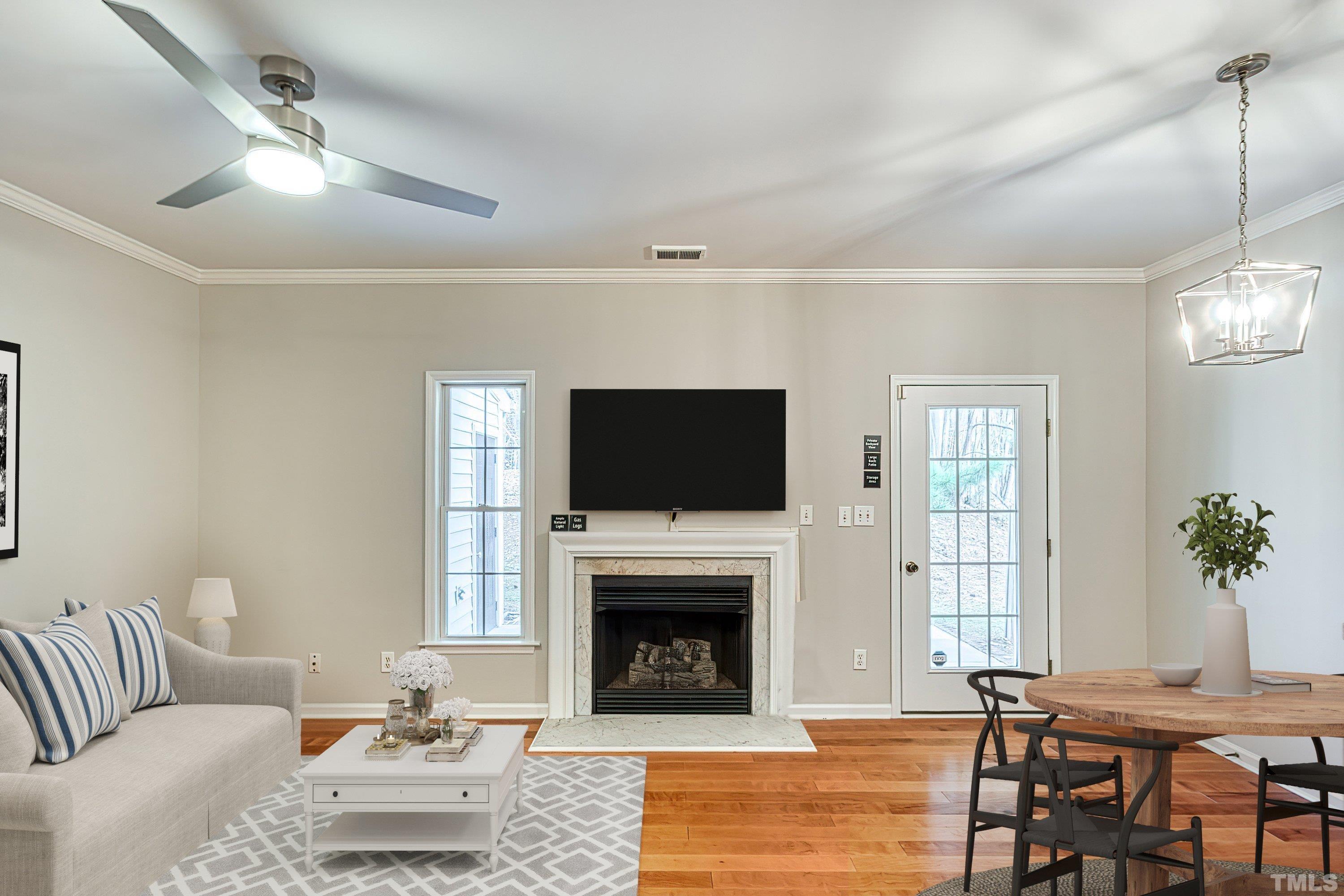 a living room with furniture a flat screen tv and a fireplace