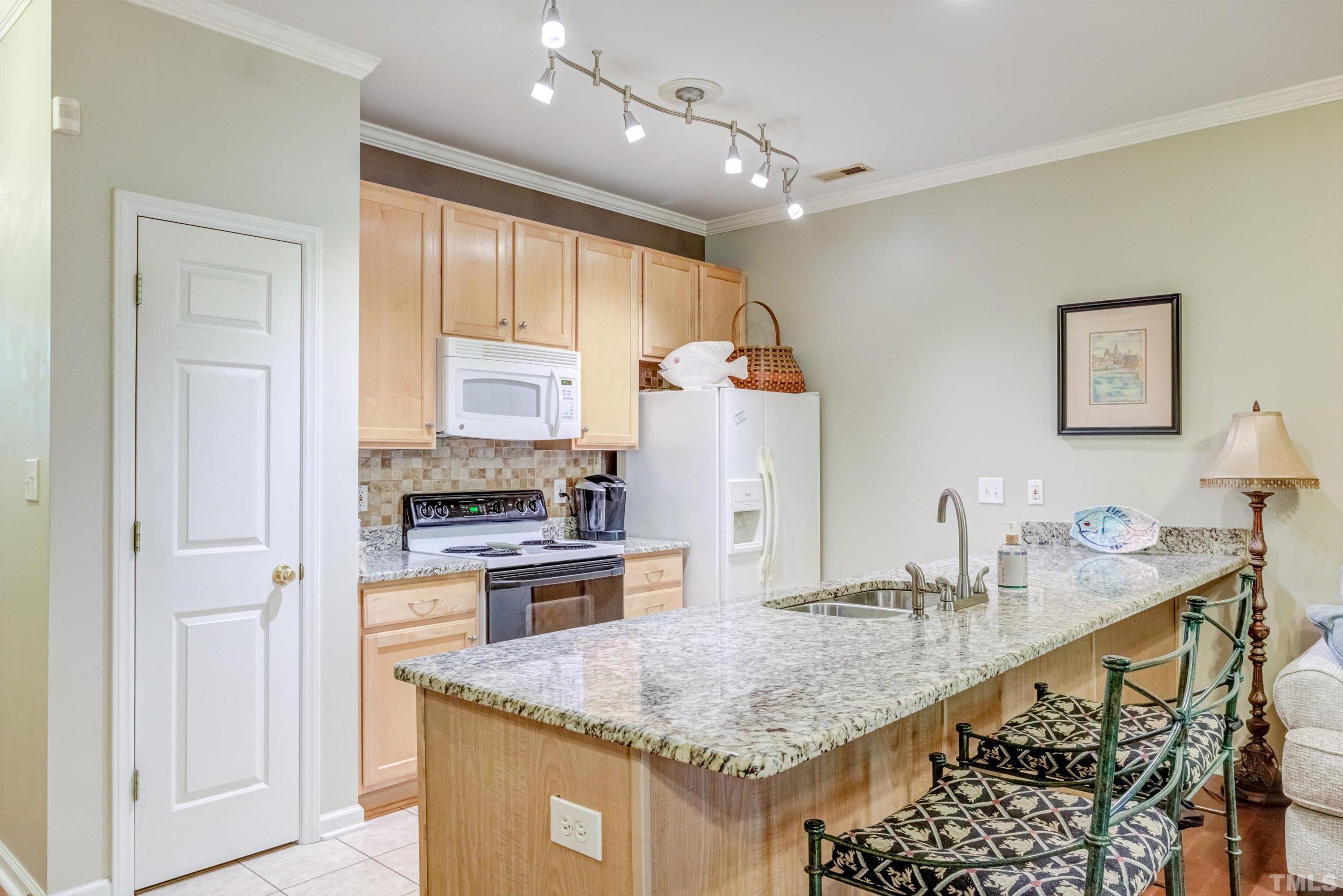 3045 Coxindale Drive Raleigh, NC 27615 - Photo 11 of 42 a kitchen with stainless steel appliances granite countertop a sink stove and refrigerator