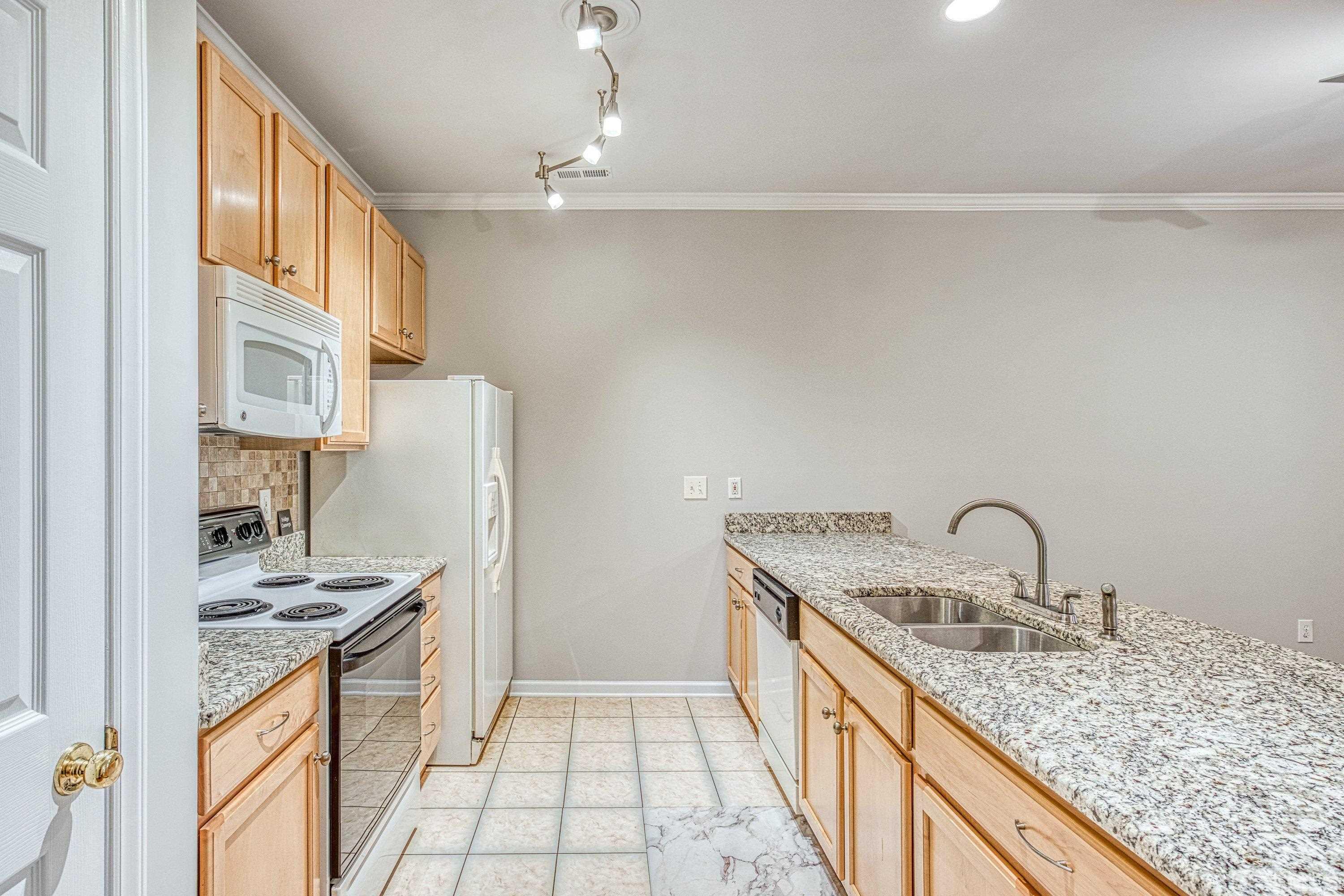 3045 Coxindale Drive Raleigh, NC 27615 - Photo 13 of 42 a kitchen with a sink stove and refrigerator