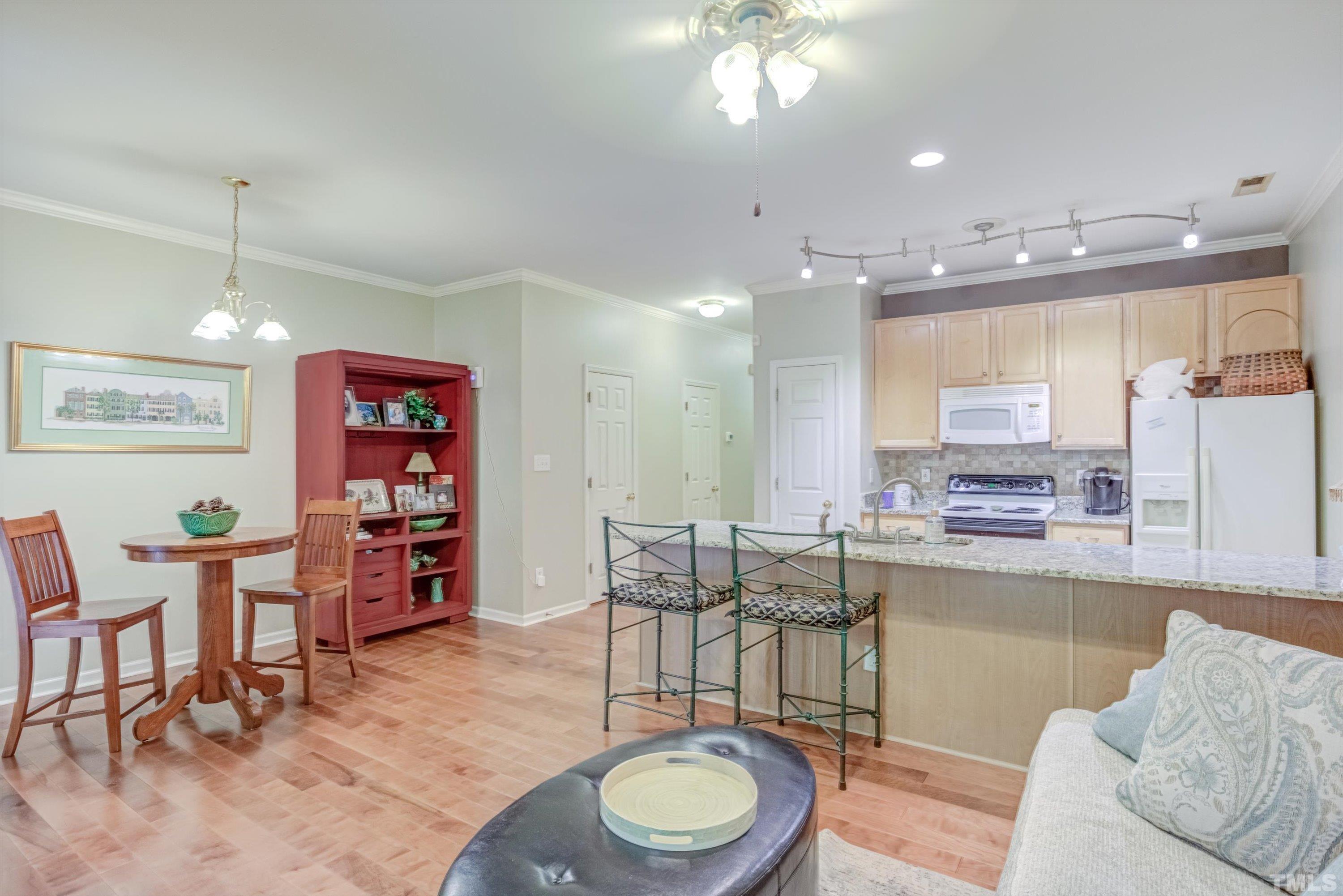 3045 Coxindale Drive Raleigh, NC 27615 - Photo 14 of 42 a living room with furniture and a wooden floor