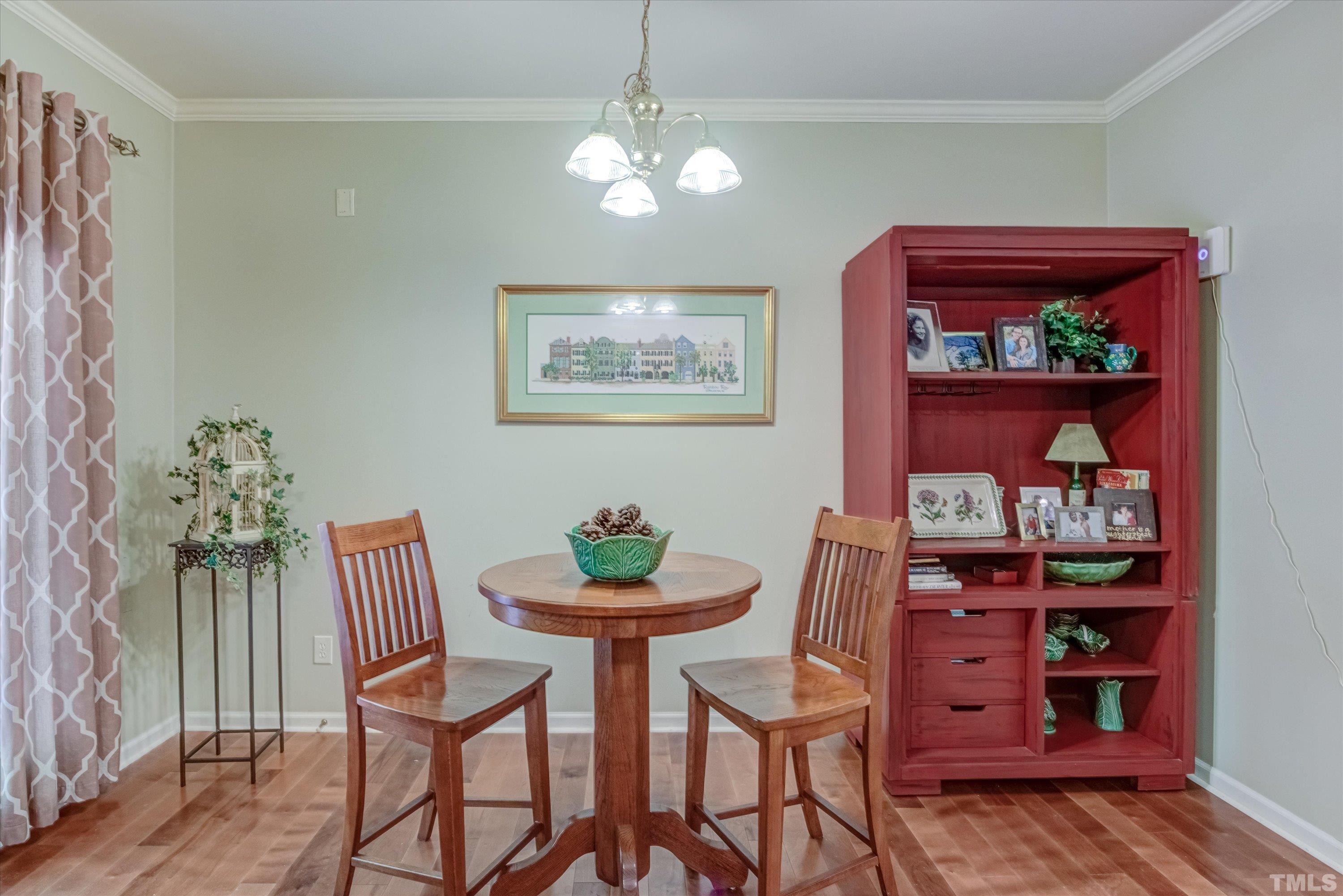 3045 Coxindale Drive Raleigh, NC 27615 - Photo 16 of 42 a view of a dining room with furniture and wooden floor