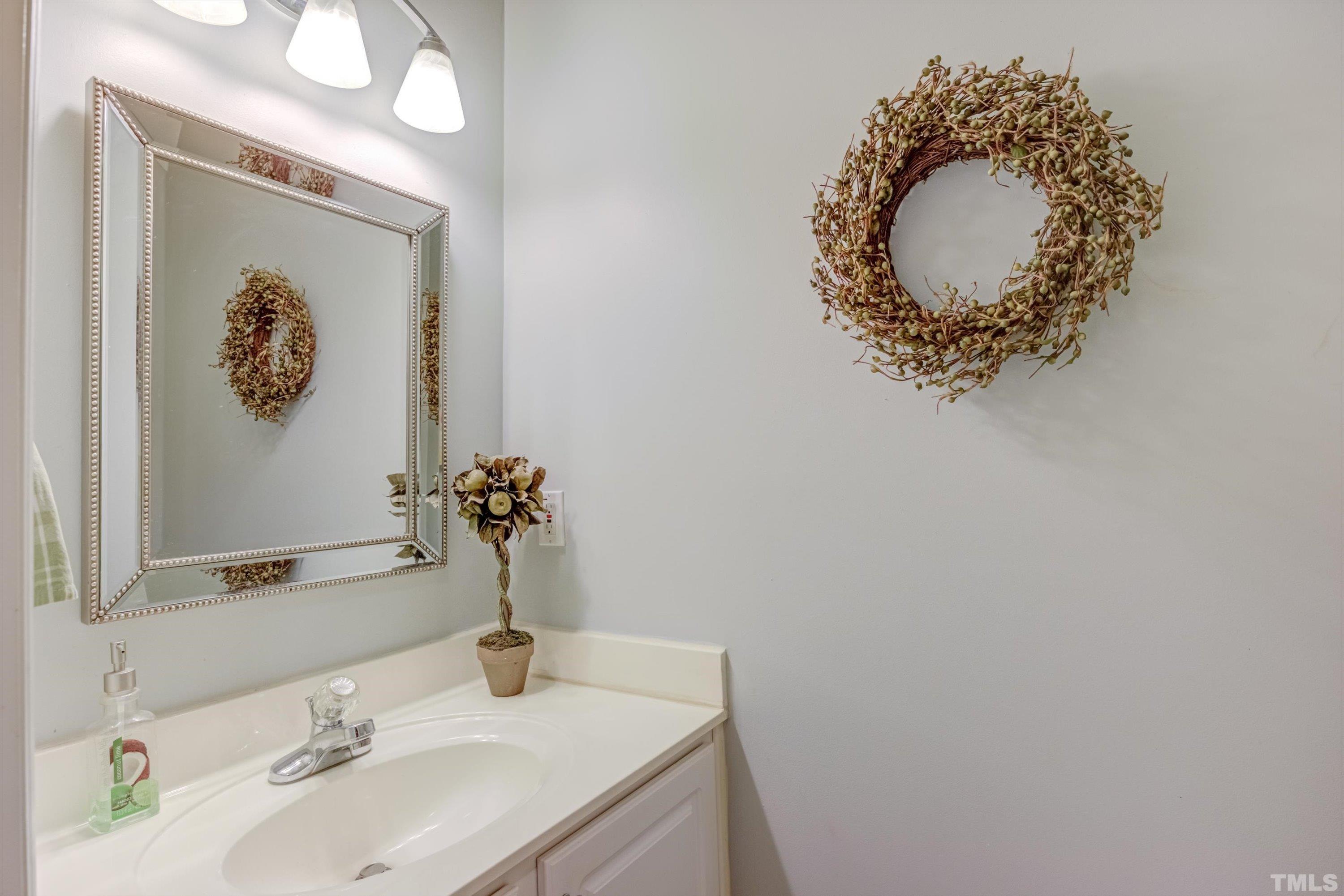 3045 Coxindale Drive Raleigh, NC 27615 - Photo 18 of 42 a bathroom with a sink and a mirror
