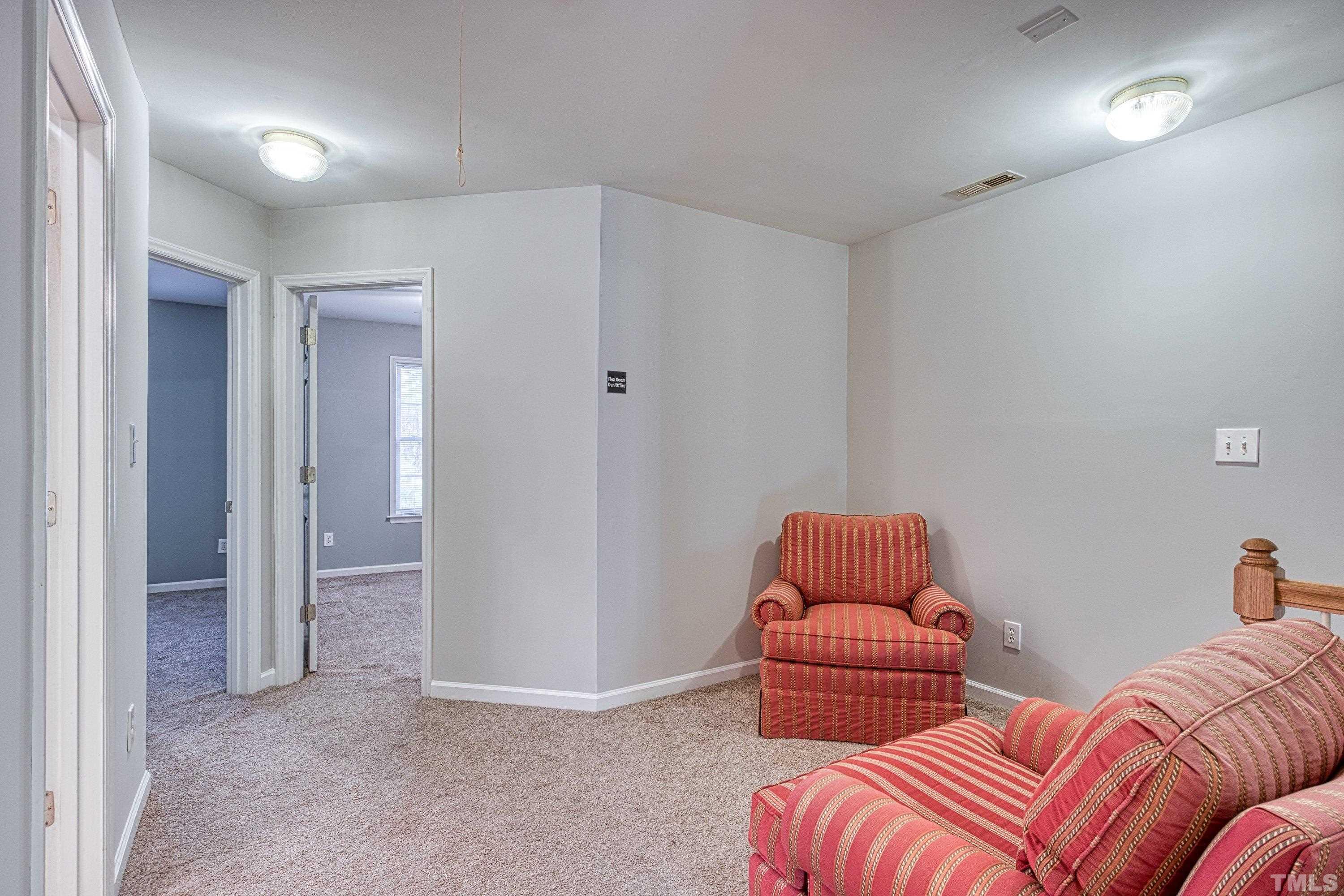 3045 Coxindale Drive Raleigh, NC 27615 - Photo 24 of 42 a bedroom with furniture and a lamp
