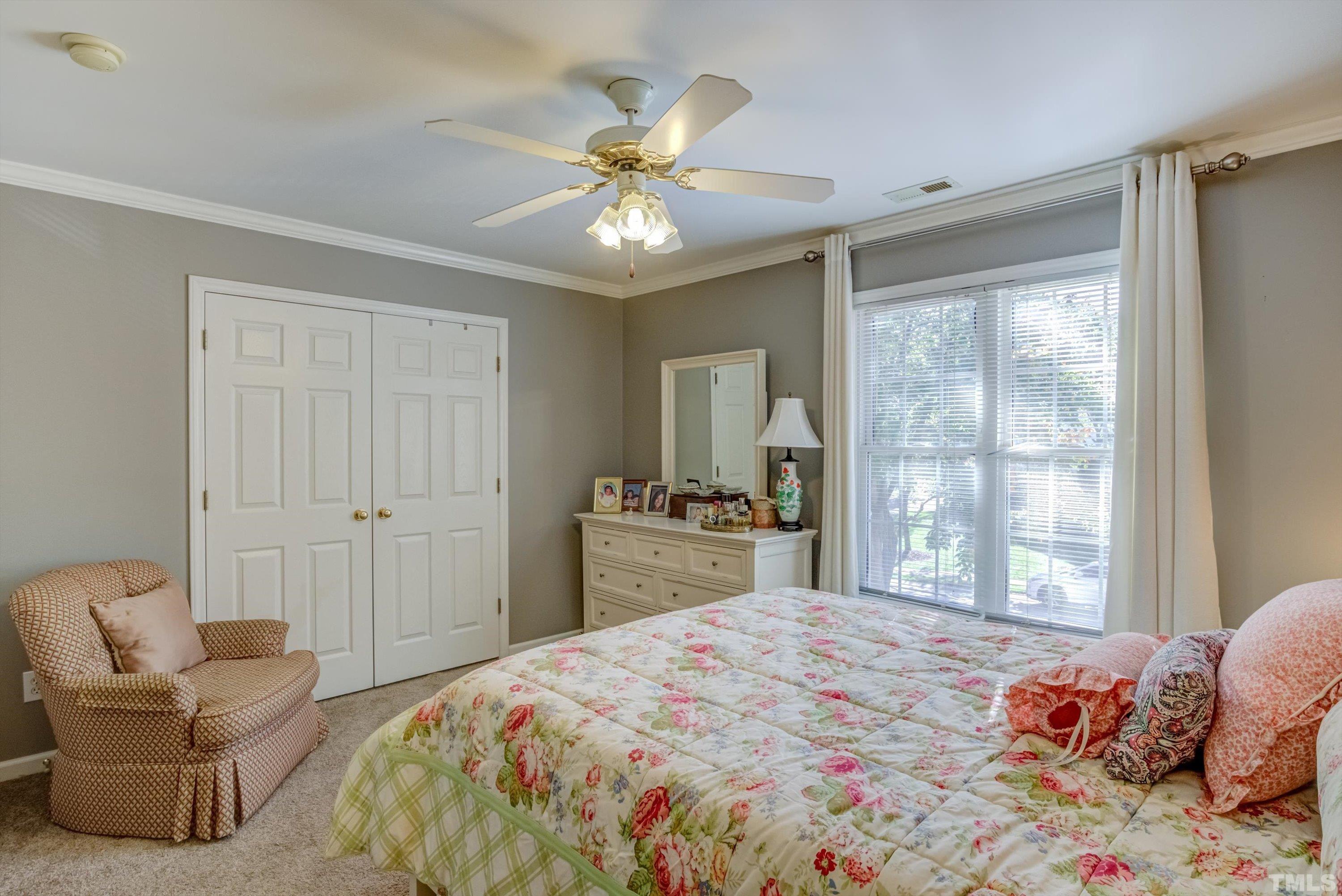 3045 Coxindale Drive Raleigh, NC 27615 - Photo 27 of 42 a bedroom with a large bed and a window