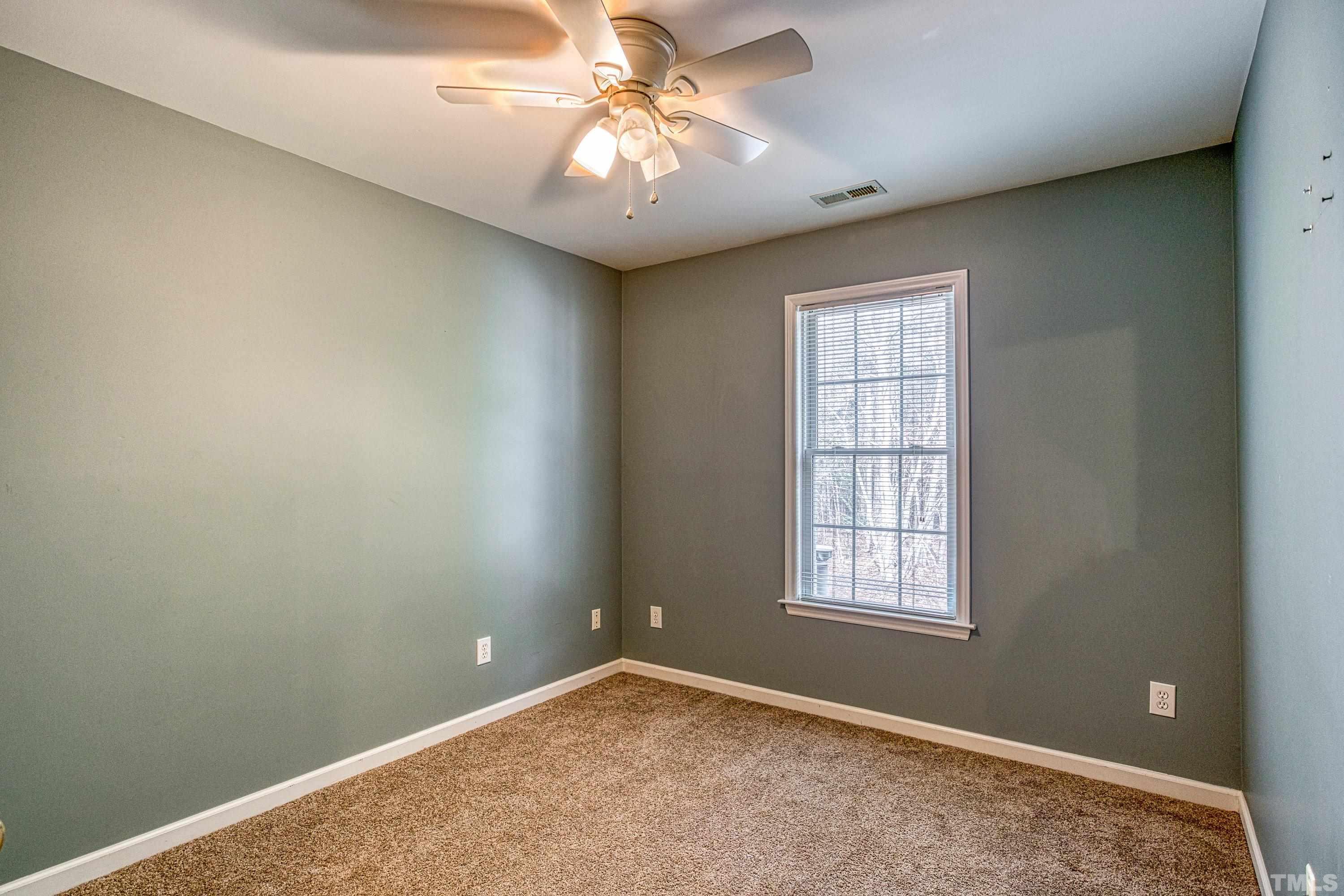 3045 Coxindale Drive Raleigh, NC 27615 - Photo 33 of 42 an empty room with windows and fan