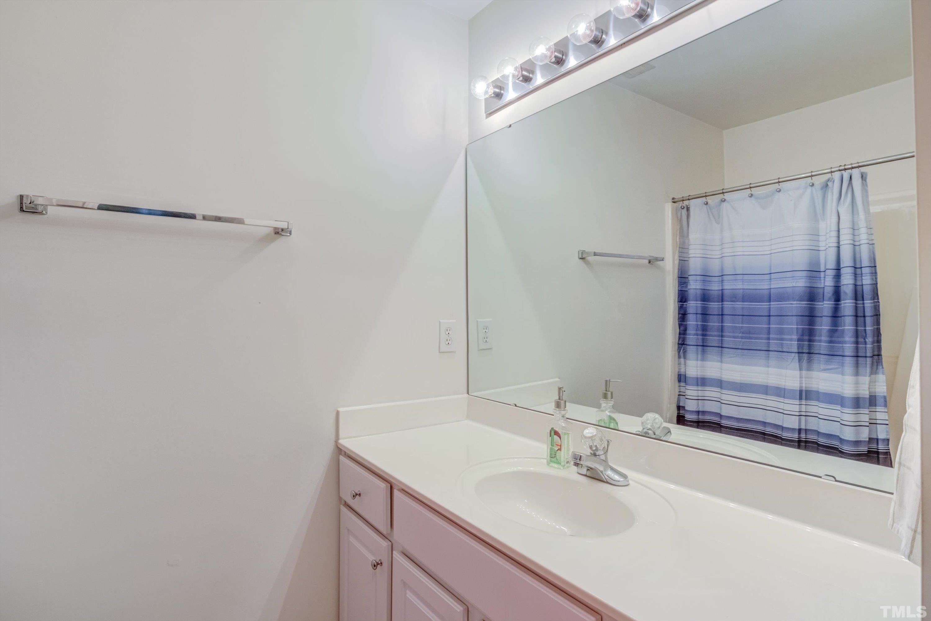 3045 Coxindale Drive Raleigh, NC 27615 - Photo 34 of 42 a bathroom with a sink and a mirror