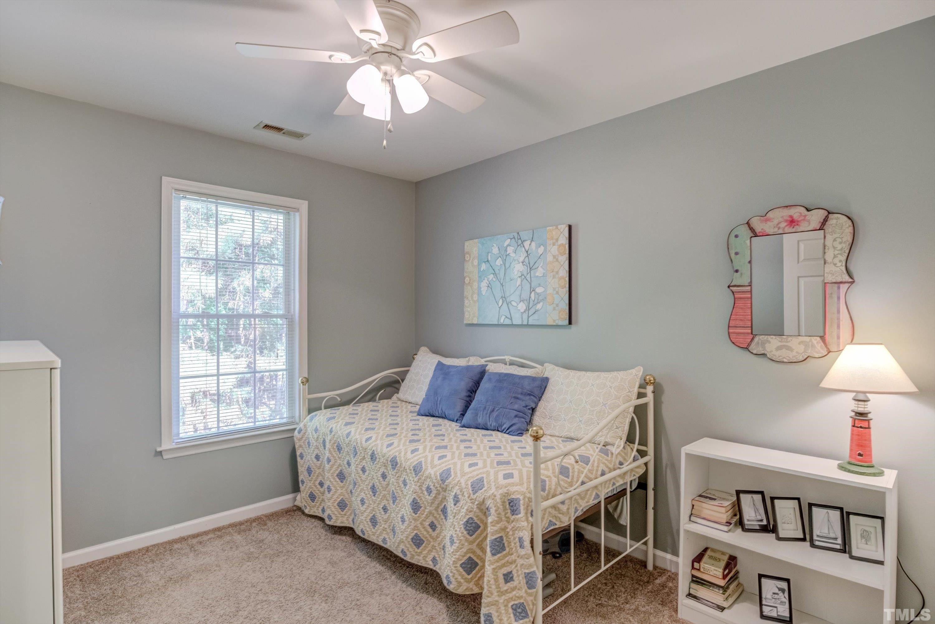 3045 Coxindale Drive Raleigh, NC 27615 - Photo 35 of 42 a bedroom with furniture and a window