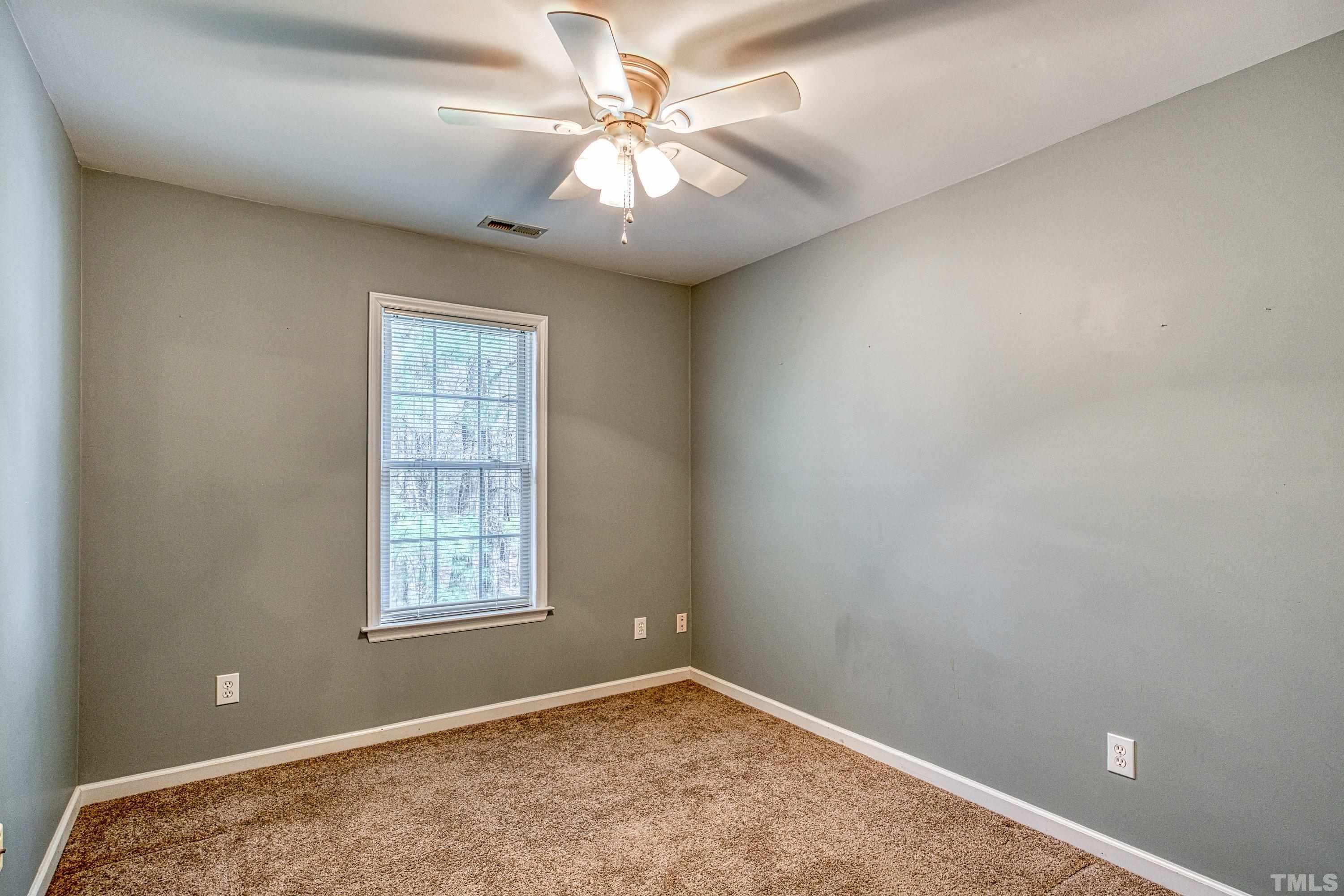 3045 Coxindale Drive Raleigh, NC 27615 - Photo 37 of 42 an empty room with windows and fan