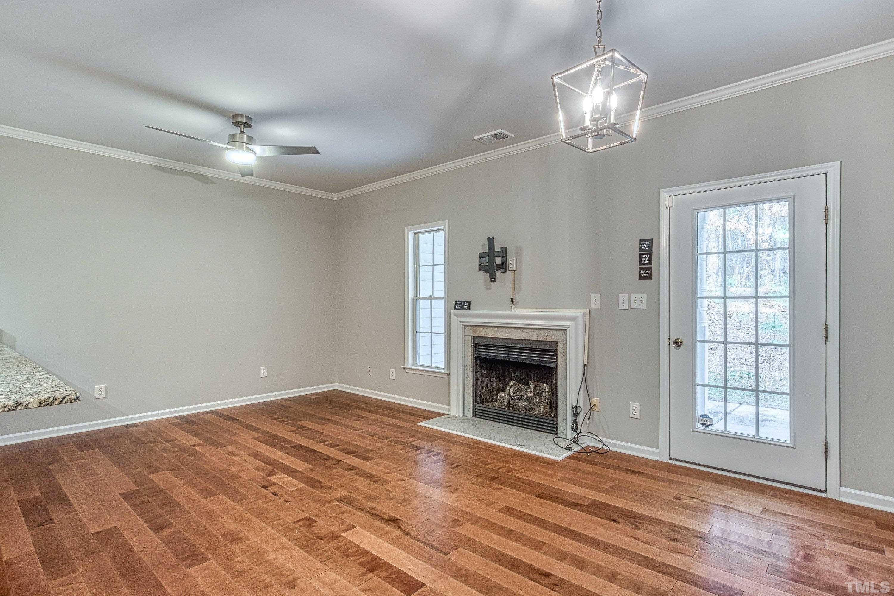 3045 Coxindale Drive Raleigh, NC 27615 - Photo 6 of 42 a view of empty room with wooden floor fan and window