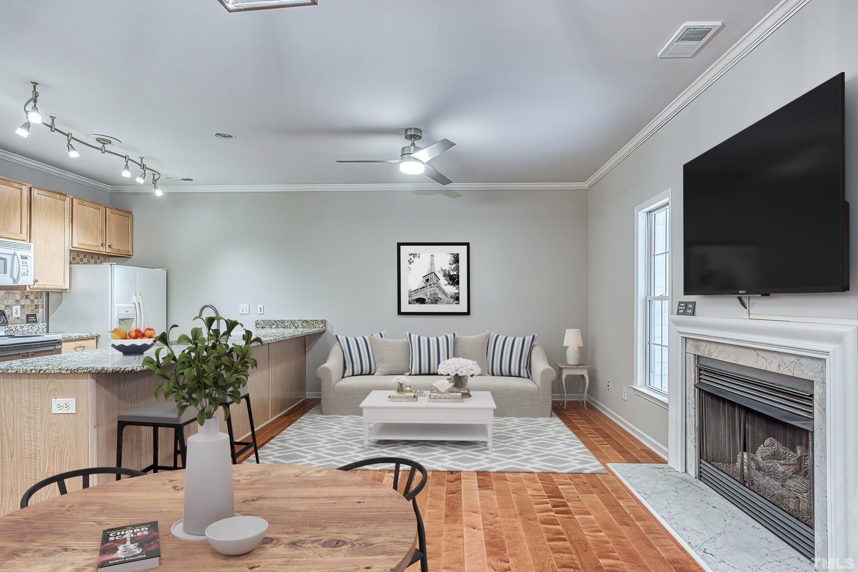 3045 Coxindale Drive Raleigh, NC 27615 - Photo 7 of 42 a living room with furniture a flat screen tv and a fireplace