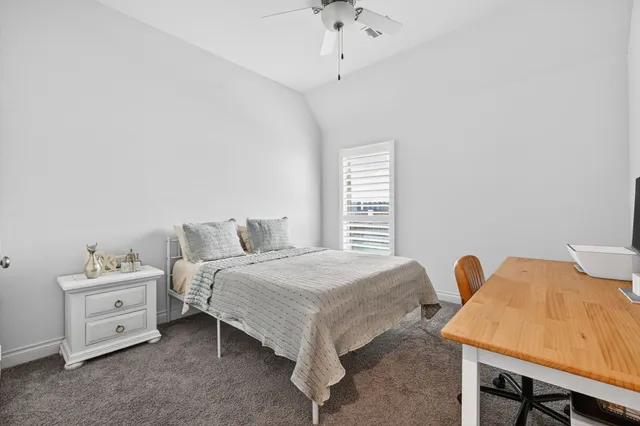 a bedroom with a bed and a table in it