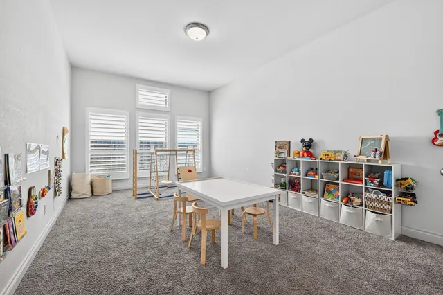 a room with furniture a bookshelf and a window