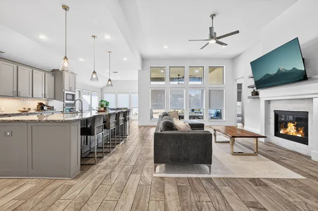 a living room with furniture a flat screen tv and a fireplace