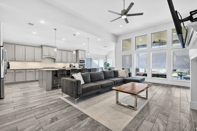 a living room with furniture and a view of kitchen
