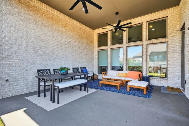 a reading room with furniture and a floor to ceiling window