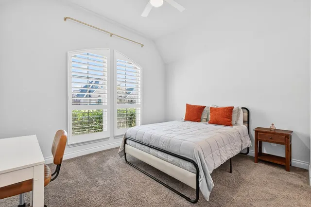 a bedroom with a bed and a chair