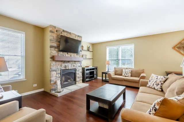a living room with furniture fireplace and flat screen tv