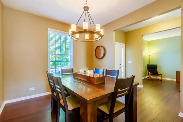 a view of a dining room with a table and chairs