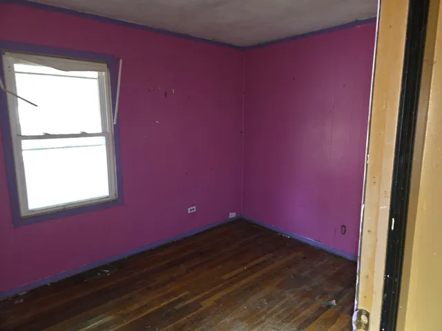 a big room with wooden floor and windows