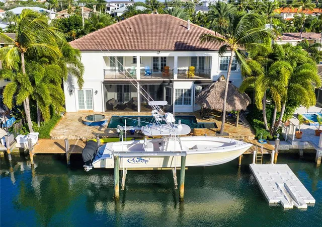 a aerial view of a house with swimming pool table and chairs