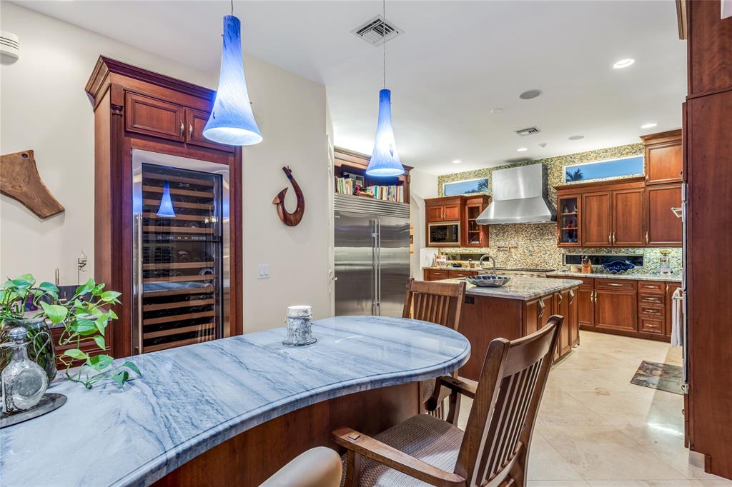 3489 Northeast 30th Avenue Lighthouse Point, FL 33064 - Photo 13 of 42 a kitchen with a table and chairs in it