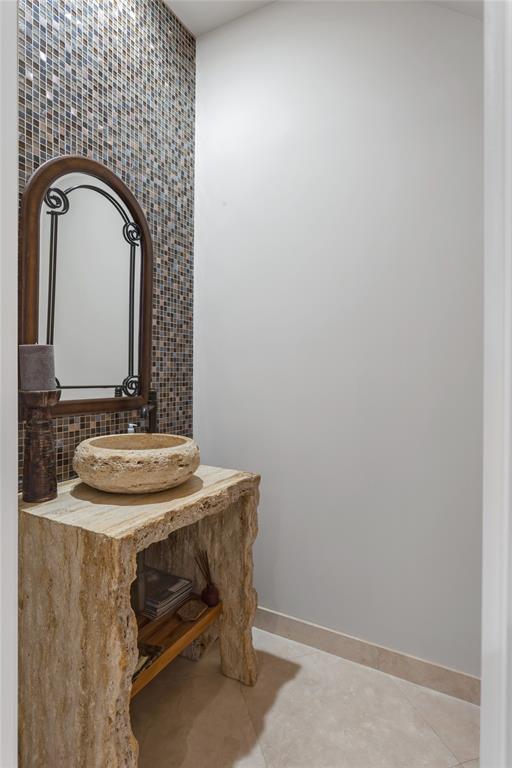 3489 Northeast 30th Avenue Lighthouse Point, FL 33064 - Photo 22 of 42 a bathroom with a sink and a mirror