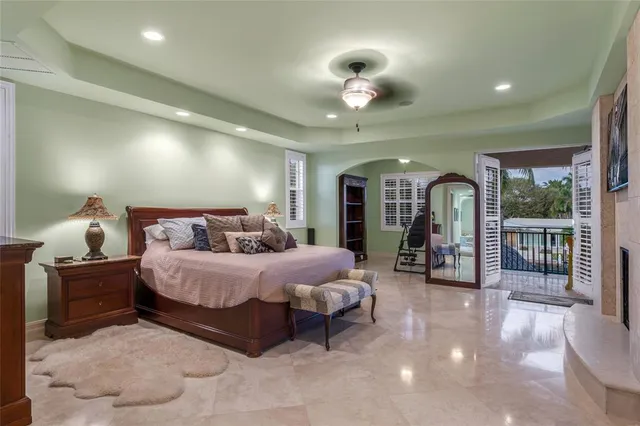 a bedroom with a large bed and a fireplace