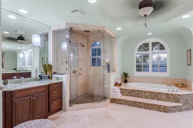 a bedroom with a large bed and wooden floor