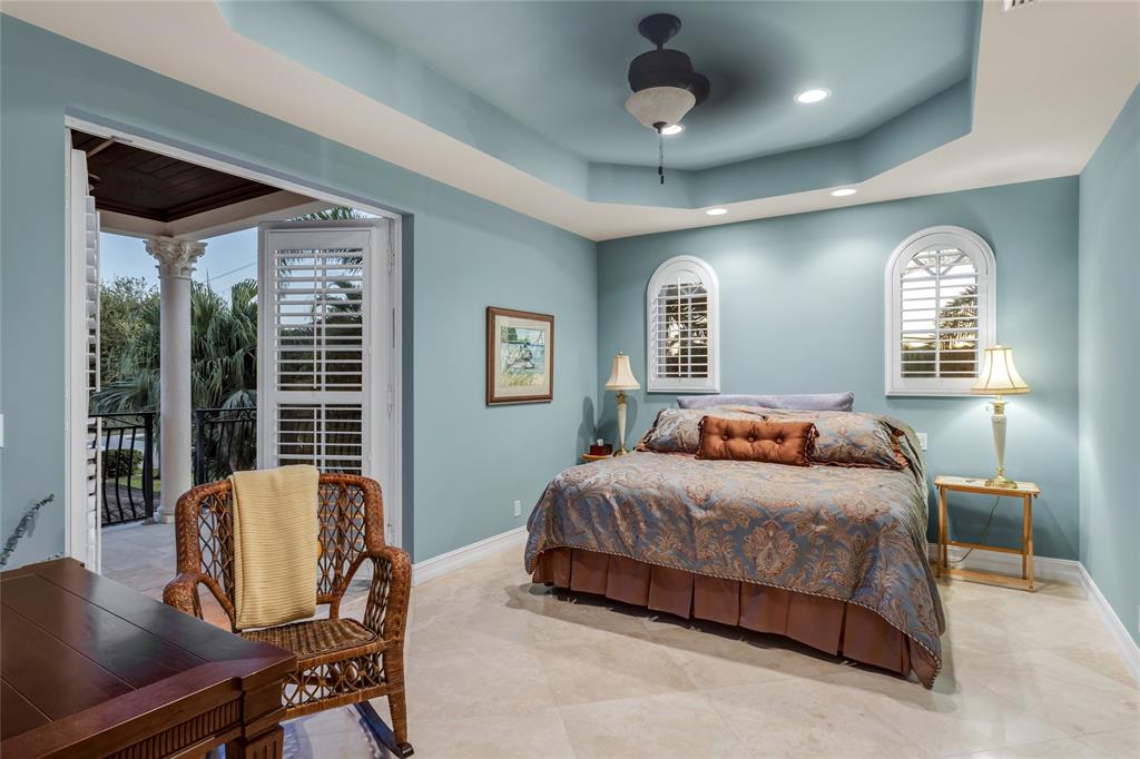 3489 Northeast 30th Avenue Lighthouse Point, FL 33064 - Photo 29 of 42 a bedroom with a large bed and wooden floor