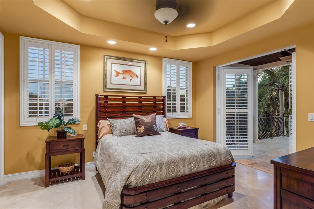 3489 Northeast 30th Avenue Lighthouse Point, FL 33064 - Photo 31 of 42 a bedroom with a large bed and a window