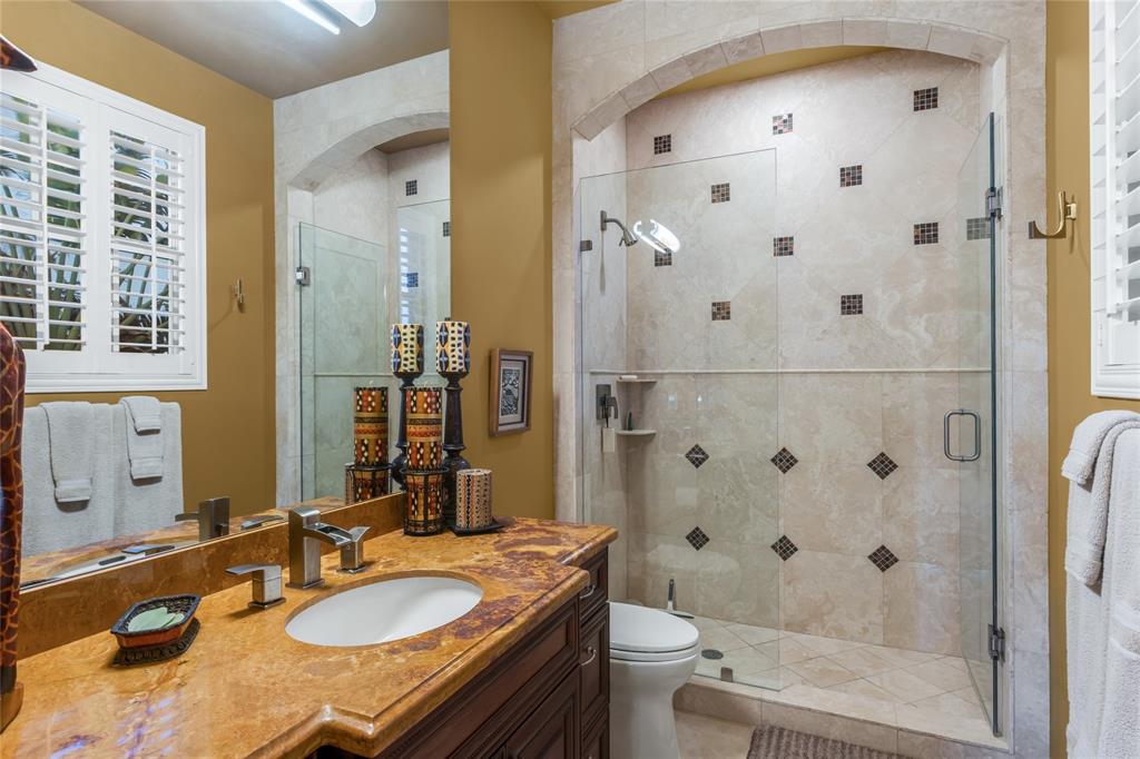 3489 Northeast 30th Avenue Lighthouse Point, FL 33064 - Photo 32 of 42 a bathroom with a granite countertop sink toilet and shower
