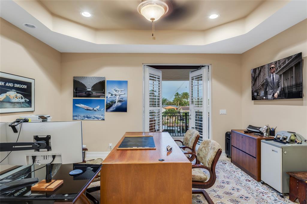 3489 Northeast 30th Avenue Lighthouse Point, FL 33064 - Photo 35 of 42 a room with furniture a flat screen tv and a window
