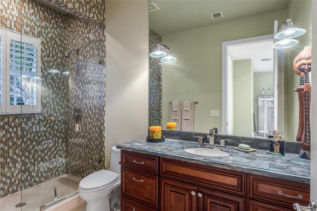 3489 Northeast 30th Avenue Lighthouse Point, FL 33064 - Photo 36 of 42 a bathroom with a granite countertop sink toilet and shower