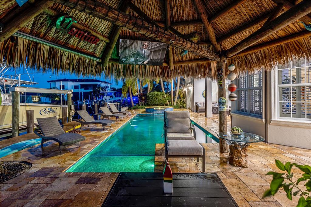 3489 Northeast 30th Avenue Lighthouse Point, FL 33064 - Photo 39 of 42 a view of a chairs and table in patio with a barbeque