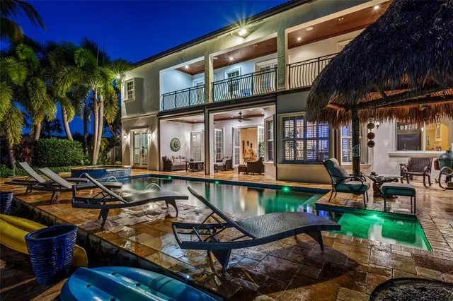 a view of swimming pool with outdoor seating and kitchen