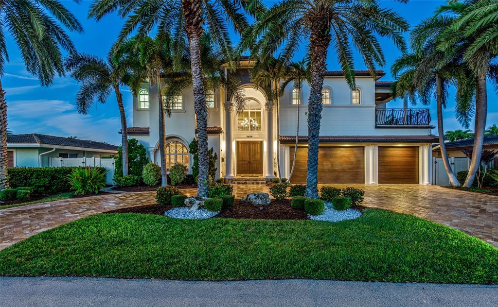 3489 Northeast 30th Avenue Lighthouse Point, FL 33064 - Photo 4 of 42 a front view of a house with garden