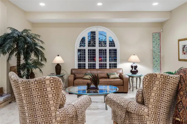 a living room with furniture a fireplace and potted plants