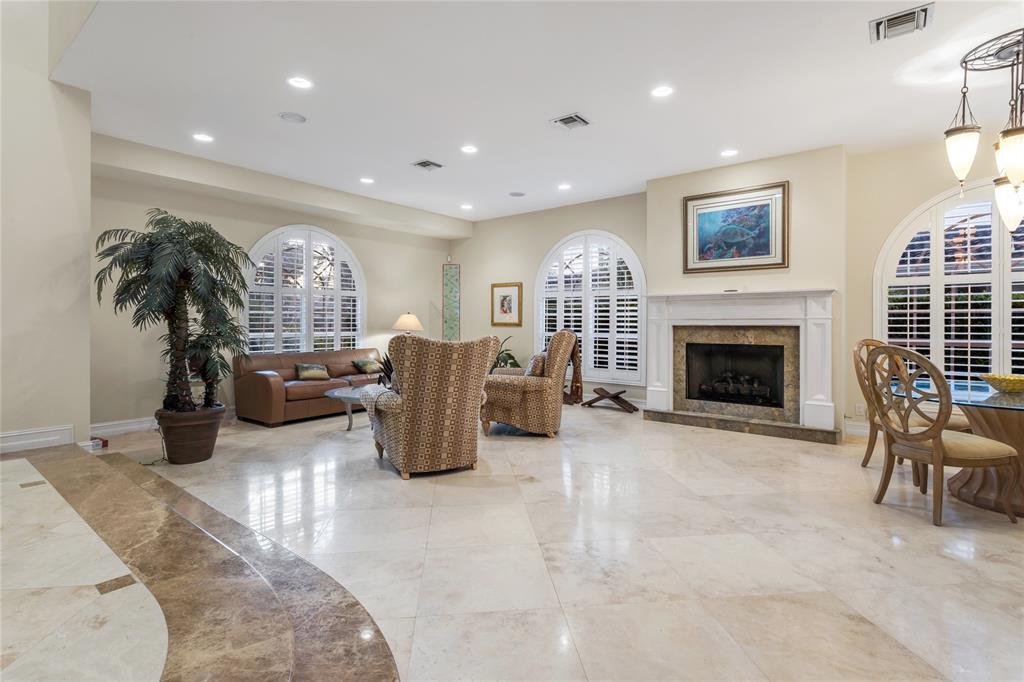 3489 Northeast 30th Avenue Lighthouse Point, FL 33064 - Photo 10 of 42 a living room with furniture a fireplace and potted plants